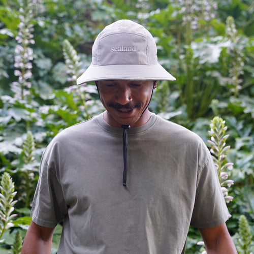Sealand packable recycled bucket hat in Forest green with mesh side panels and chin strap